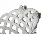a white basket sitting on top of a table