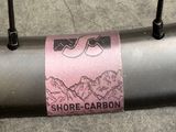 a bike tire with a sticker on it that says shore - carbon