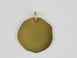 a gold plated pendant with a small disc on a white background