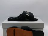 the black slippers are sitting on top of a white box