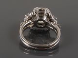 a close up of a diamond ring on a black surface