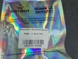 someone is holding up a plastic bag with a sticker on it