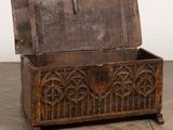 an old wooden chest sitting on top of a hard wood floor