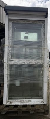 a picture of a window in a building with a sky background