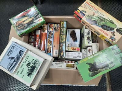 a cardboard box filled with assorted items on the floor