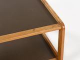 a small wooden table with a glass top on a white surface
