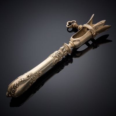 an antique silverware knife with a handle on a black surface