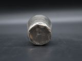 close up of a metal object on a table with a black background