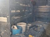many boxes and containers in the back of a truck