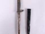 an old knife and a small knife sitting next to each other
