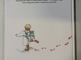 a book with a picture of a little boy holding a kite