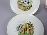 three plates with pictures of animals on them sitting on a table