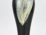 a black vase with a white and yellow design on it