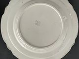 an image of a white plate sitting on top of a black table