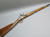a rifle with a wooden barrel and brass fittings on it