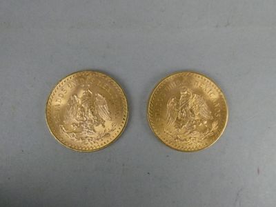two pieces of gold coins sitting on top of a table