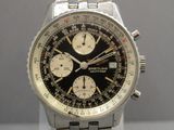 a close up of a watch with a black face