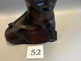 a bronze sculpture of a man ' s foot with a number 52 on it