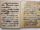 an open book with stamps on it on a table