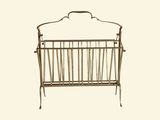 a small metal crib with a baby ' s crib in it