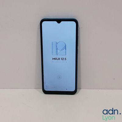 the back of a phone with a logo on it sitting on a table
