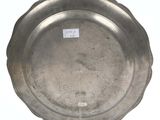 an antique silver plate on a stand with a tag on it