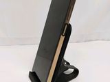 an image of a cell phone on a stand on a white surface