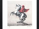 a black and white drawing of a man on a horse with a red cape