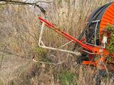 a large orange sprinkler in the middle of a field