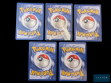 four plastic pokemon keychains are shown on a black background