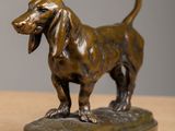 bronze statue of a dog on a base on a table