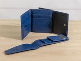 a blue wallet sitting on top of a wooden table