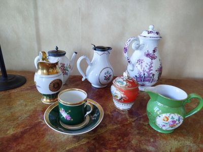 many different types of teapots and cups on the table