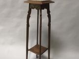 a small wooden table with a shelf on it