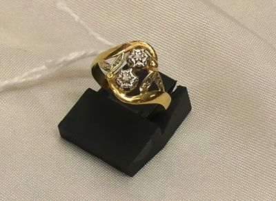 an image of a gold and diamond ring on a black stand