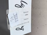 a tag attached to a white vase with a tag attached to it