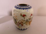 a white vase with a blue border and a picture of people on it