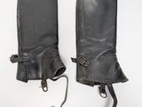 pair of black leather gaiters on a white background
