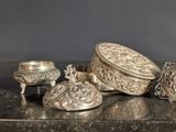 a lot of silver items sitting on a table
