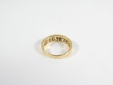 a close up of a gold ring on a white surface