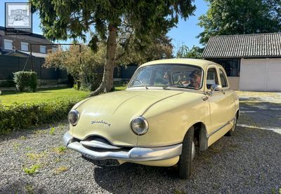 a yellow car parked in front of a house