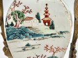 a vase with a painting on it sitting on a table