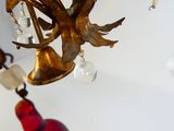 a gold chandelier with glass ornaments hanging from it