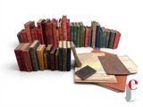 a lot of books that are stacked together on top of each other