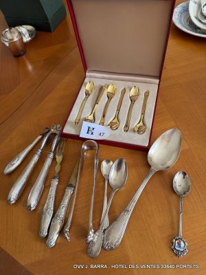 a lot of silverware on a table with a red box