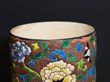 a close up of a vase with flowers on it
