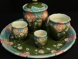 une photo d'un service à thé composé de quatre tasses et d'une soucoupe
