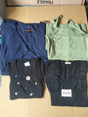 three pairs of men ' s t - shirts in a box on a table