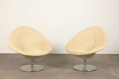 pair of lounge chairs in the style of the egg chair