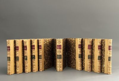 six books are stacked on top of each other on a gray surface